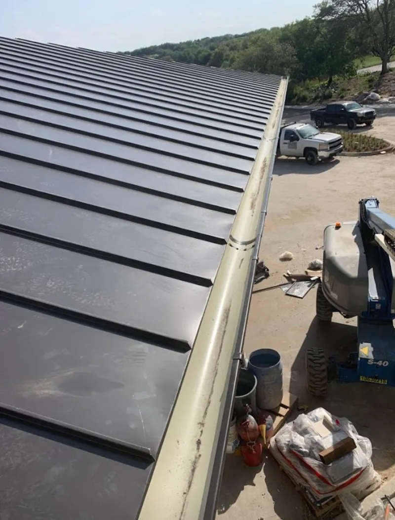 Standing seam panel and gutter detail on a metal roofing jobsite in York